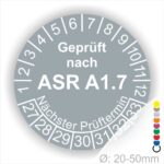 Prüfplaketten, Prüfetiketten rund, Farbe- Grau, Text "Geprüft nach ASR A1.7" in Weiß. Startjahr- 27, Monatszahlen Oben und Jahreszahlen Unten in Kreisform über den Jahreszahlen Text "Nächster Prüftermin".