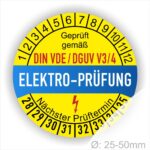 VDE DGUV Plakette rund, Farbe- Gelb in der Mitte ein Streifen in Blau, Text oberer Teil "Geprüft gemäß DIN-VDE/DGUV V3/4" in Schwarz. Mittig Streifen in Rot mit dem Text " ELEKTRO-PRÜFUNG", danach Elektropfeil in Rot Startjahr- 28, Monatszahlen Oben und Jahreszahlen Unten in Kreisform. Über den Jahreszahlen Text "Nächster Prüftermin"