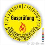 Prüfplaketten, Prüfetiketten rund, Farbe- Gelb, Text "Gasprüfung" in Schwarz danach eine Flamme als Pictogramm oder Icon in Rot, Startjahr- 26, Monatszahlen Oben und Jahreszahlen Unten in Kreisform. Über den Jahreszahlen Text "Nächster Prüftermin"