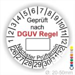 Prüfplakette rund mit Text geprüft nach DGUV Regel danach Beschriftungsfeld in Weiß und Text Nächster Prüftermin. Plaketten Farbe- Weiß und Text in Schwarz. Monatszahlen oben und Jahreszahlen unten beginnend mit Startjahr- 26. Durchmesser 20-50mm frei wählbar.