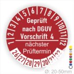 Prüfplakette mit Text Geprüft nach Dguv Vorschrift 4 und Nächster Prüftermin mit zwischen Strich in Weiss. Plaketten Farbe- Rot und Text in Weiss. Monatszahlen oben und Jahreszahlen unten beginnend mit Startjahr- 26