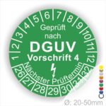 Prüfplakette rund mit Text geprüft nach Dguv Vorschrift 3 danach Elektropfeilund Text Nächster Prüftermin. Plaketten Farbe- Grün und Text in Weiß. Monatszahlen oben und Jahreszahlen unten beginnend mit Startjahr- 26.