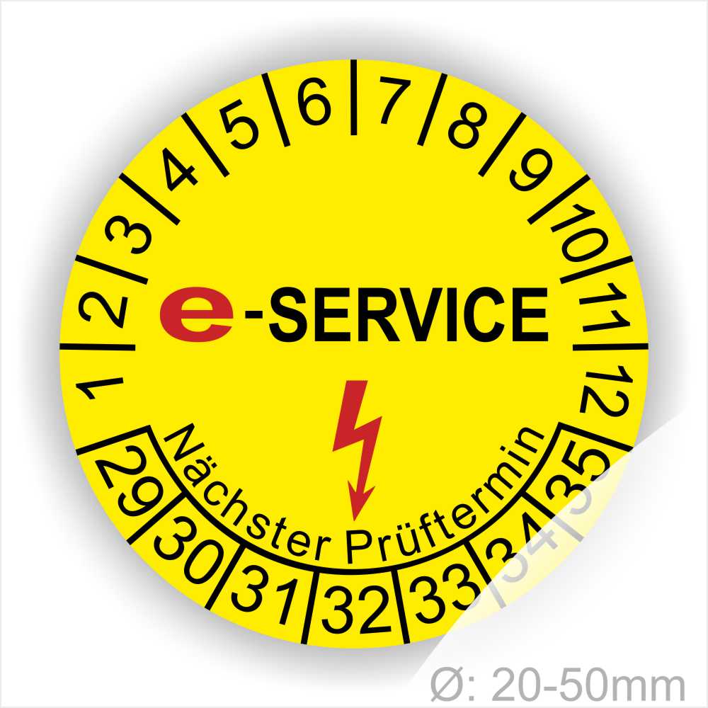 Prüfplaketten rund, Farbe- Gelb, Text "E-SERVICE" in Schwarz danach ein Elektro- Pfeil in Rot, Startjahr- 29, Monatszahlen Oben und Jahreszahlen Unten in Kreisform. Über den Jahreszahlen Text "Nächster Prüftermin"