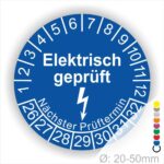 Prüfplaketten rund Farbe- Blau, Text "Elektrisch geprüft" in Weiß danach ein Elektro- Pfeil in Weiß, Startjahr- 26, Monatszahlen Oben und Jahreszahlen Unten in Kreisform