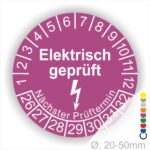 Prüfplaketten rund Farbe- Lila, Text "Elektrisch geprüft" in Weiß danach ein Elektro- Pfeil in Weiß, Startjahr- 26, Monatszahlen Oben und Jahreszahlen Unten in Kreisform