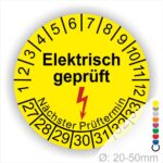 Prüfplaketten rund Farbe- Gelb, Text "Elektrisch geprüft" in Schwarz danach ein Elektro- Pfeil in Rot, Startjahr- 27, Monatszahlen Oben und Jahreszahlen Unten in Kreisform