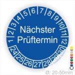 Prüfplakette mit Text Nächster Prüftermin Startjahr- 26, Monatszahlen Oben und Jahreszahlen Unten in Kreisform. Farbe Blau