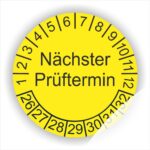 Wartungsaukleber, Prüfplakette mit Text Nächster Prüftermin Startjahr- 26, Monatszahlen Oben und Jahreszahlen Unten in Kreisform. Farbe Gelb