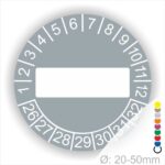 Prüfplaketten, Prüfetikett rund, Farbe- Grau, Text " in Weiß. Als nächstes kommt ein Beschriftungfeld / Leerfeld in Farbe Weiß. Startjahr- 26, Monatszahlen Oben und Jahreszahlen Unten in Kreisform.