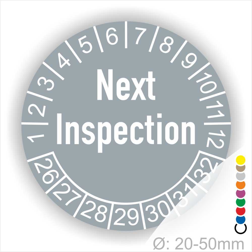 Prüfetiketten, Prüfaukleber rund, Farbe- Grau, Text auf Englisch "Next Inspection" in Weiß. Startjahr- 26, Monatszahlen Oben und Jahreszahlen Unten in Kreisform.