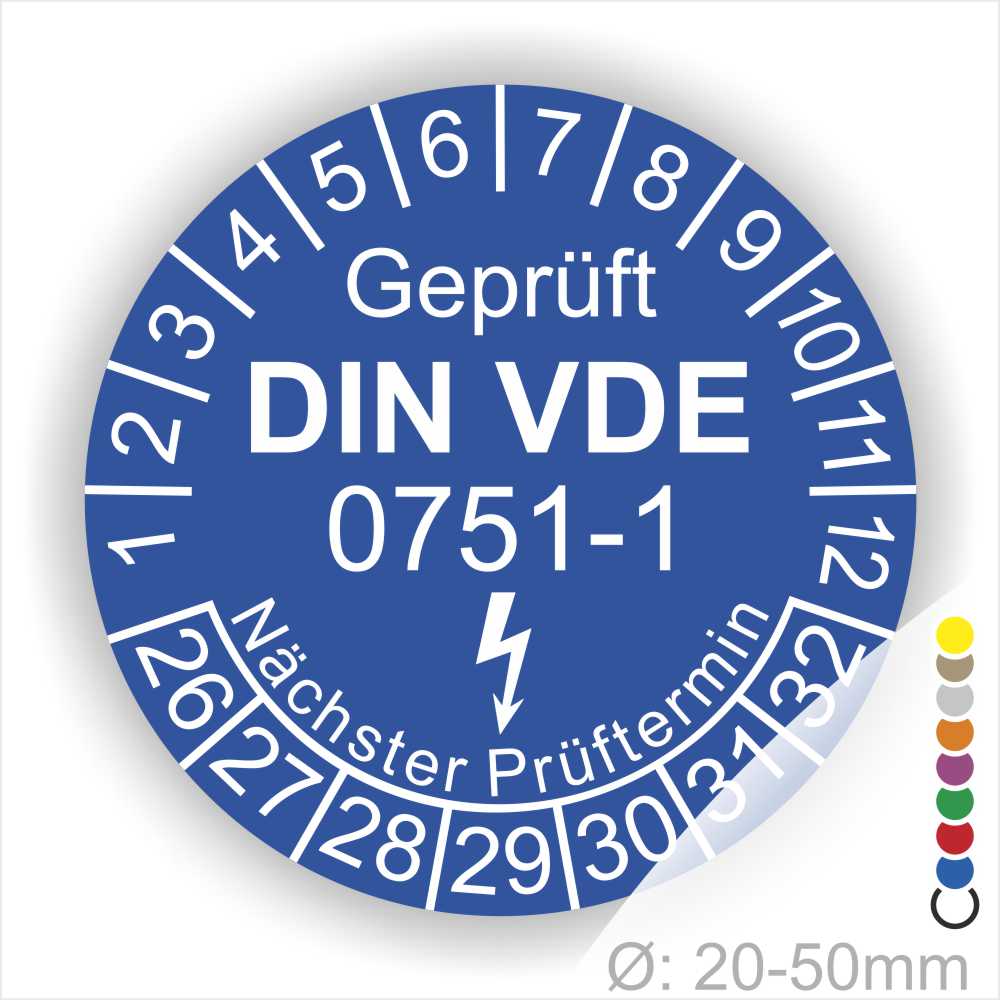 Prüfplaketten rund, Farbe- Blau, Text "Geprüft gemäß DIN VDE 0751-1" in Weiß danach ein Elektro- Pfeil in Weiß, Startjahr- 26, Monatszahlen Oben und Jahreszahlen Unten in Kreisform. Über den Jahreszahlen Text "Nächster Prüftermin"