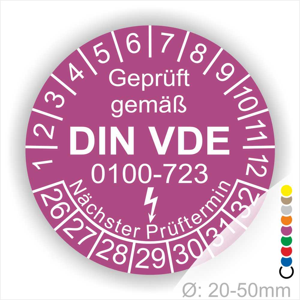 Prüfetiketten rund, Farbe- Lila, Text "Geprüft gemäß VDE 0100-0723" in Weiß danach ein Elektro- Pfeil in Weiß, Startjahr- 26, Monatszahlen Oben und Jahreszahlen Unten in Kreisform. Über den Jahreszahlen Text "Nächster Prüftermin"