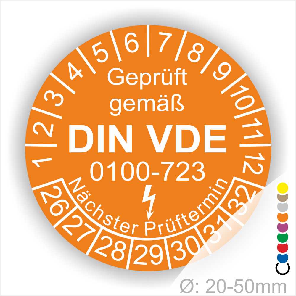 Prüfetiketten rund, Farbe- Orange, Text "Geprüft gemäß VDE 0100-0723" in Weiß danach ein Elektro- Pfeil in Weiß, Startjahr- 26, Monatszahlen Oben und Jahreszahlen Unten in Kreisform. Über den Jahreszahlen Text "Nächster Prüftermin"