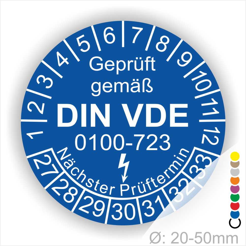 Prüfaufkleber rund, Farbe- Blau, Text "Geprüft gemäß VDE 0100-0723" in Weiß danach ein Elektro- Pfeil in Weiß, Startjahr- 27, Monatszahlen Oben und Jahreszahlen Unten in Kreisform. Über den Jahreszahlen Text "Nächster Prüftermin"