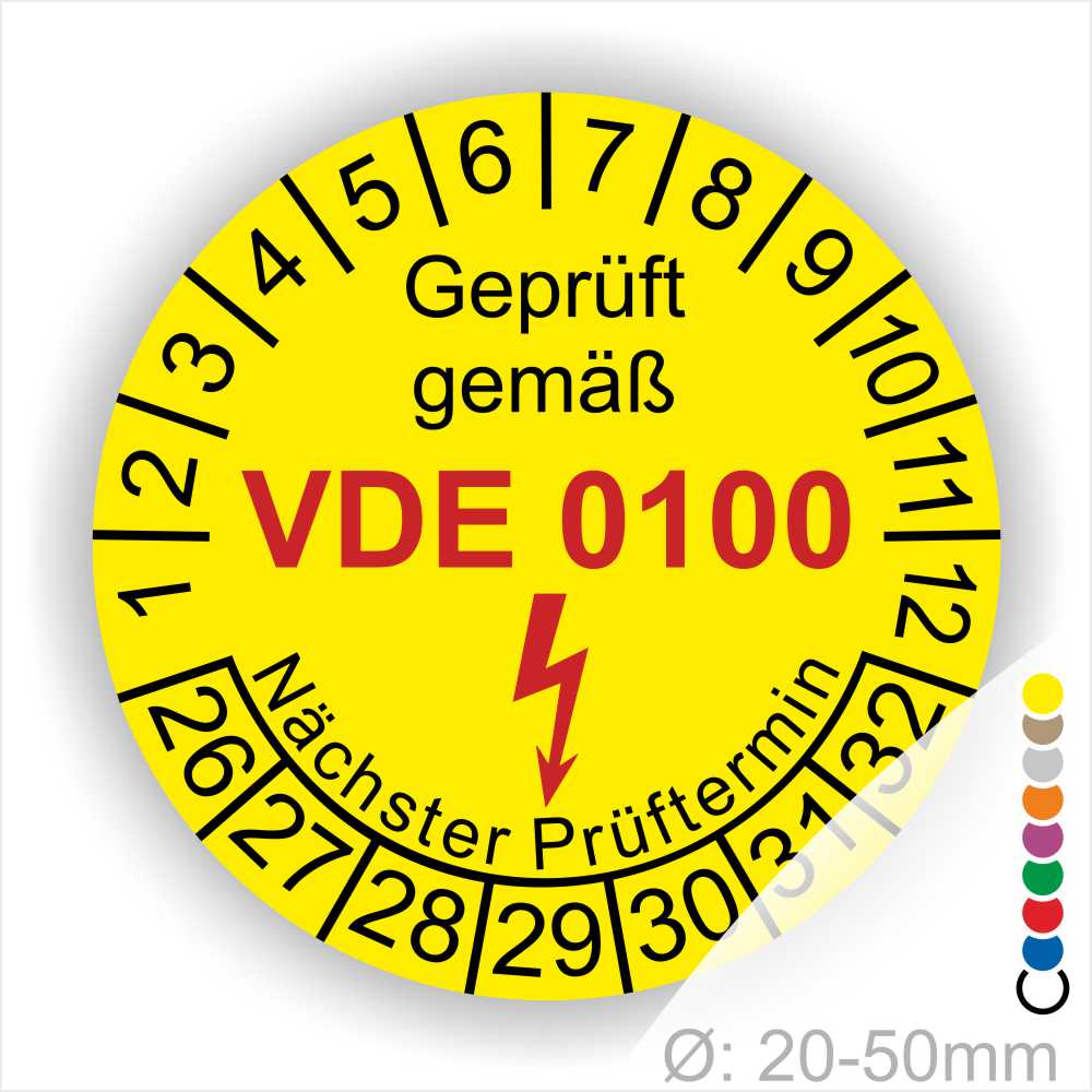 Prüfplaketten rund Farbe- Gelb, Text "Geprüft gemäß VDE 0100" in Schwarz danach ein Elektro- Pfeil in Rot, Startjahr- 26, Monatszahlen Oben und Jahreszahlen Unten in Kreisform. Über den Jahreszahlen Text "Nächster Prüftermin"