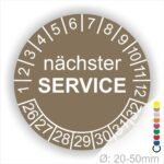 Prüfplaketten, Prüfetiketten rund, Farbe- Braun, Text "nächster SERVICE" in Weiß. Startjahr- 26, Monatszahlen Oben und Jahreszahlen Unten in Kreisform.