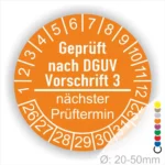 Sicherheitsprüfung Aufkleber nach DGUV Vorschrift 3, orange Rundetikett mit Prüfdatum und nächstem Prüftermin, Durchmesser 20-50 mm.