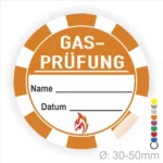 Runder Aufkleber für Gasprüfungen mit Platz für Name und Datum, orangefarbenes Design mit Flammensymbol, Durchmesser 30-50 mm. Ideal für Sicherheitsprüfungen und Dokumentationen.