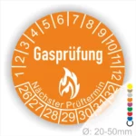 Gasprüfungs-Plakette mit orangefarbenem Design, die den nächsten Prüftermin anzeigt. Durchmesser von 20-50 mm, geeignet für die Kennzeichnung von Gasprüfungen.