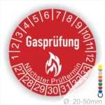 Gasprüfung Prüfplakette rot mit Flammensymbol, Monatsring 1–12 und Jahresfeld ab 2027 zur Kennzeichnung des nächsten Prüftermins bei Gasinstallationen