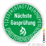 Runder Aufkleber zur Kennzeichnung des nächsten Gasprüfungsdatums, grün mit weißen Zahlen und dem Text "Nächste Gasprüfung" sowie einem Flammensymbol. Ideal für die sichere Nutzung von Gasgeräten. Durchmesser 20-50 mm.