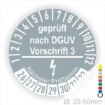 Prüfsiegel nach DGUV Vorschrift 3 für Geräte mit einem Durchmesser von 20-50 mm, inklusive nächstem Prüftermin und Farbcodes zur Kennzeichnung.