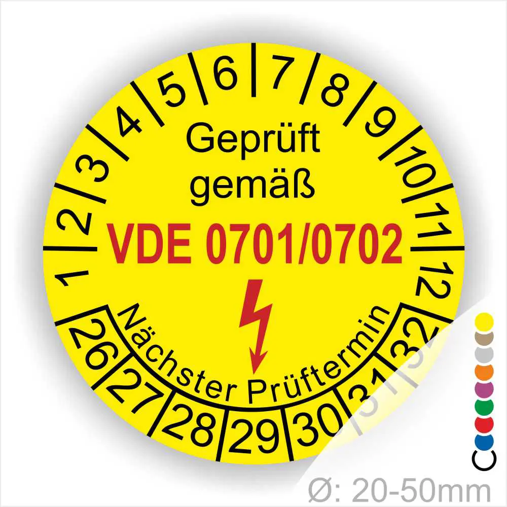 Gelbes Prüflabel mit der Aufschrift „Geprüft gemäß VDE 0701/0702“, das den nächsten Prüftermin anzeigt. Das Label hat einen Durchmesser von 20-50 mm und enthält eine Blitzsymbolik zur Kennzeichnung elektrischer Sicherheit.