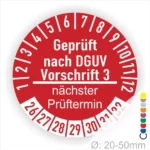 Rotes Prüfzeichen nach DGUV Vorschrift 3 mit nächstem Prüftermin, Durchmesser 20-50mm, für sicherheitsrelevante Geräte und Anlagen.