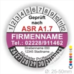 Prüfsiegel nach ASR A1.7 mit Firmenname, Telefonnummer und nächstem Prüftermin, abgebildet auf einem runden, farbigen Hintergrund.