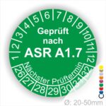 Grünes Prüfzeichen mit der Aufschrift "Geprüft nach ASR A1.7" und Angaben zum nächsten Prüftermin, Durchmesser von 20-50 mm.