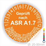 Prüfsiegel für Sicherheits- und Gesundheitsschutz, orangefarbener Kreis mit der Aufschrift "Geprüft nach ASR A1.7", Angaben zum nächsten Prüftermin und Durchmesser von 20-50 mm.
