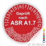 Runder Prüfaufkleber in Rot, der anzeigt, dass eine Prüfung nach ASR A1.7 durchgeführt wurde. Der Aufkleber enthält Zahlen von 1 bis 12 und Jahreszahlen 26 bis32 für den nächsten Prüftermin und ist lieferbar Durchmesser von 20-50 mmt.