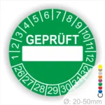 Grünes Prüfetikett mit der Aufschrift "GEPRÜFT" und Platz für eine individuelle Kennzeichnung, geeignet für die Verwendung auf Objekten mit einem Durchmesser von 20-50 mm.