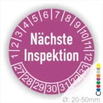 Runder Aufkleber zur Anzeige des nächsten Inspektionsdatums, lila mit weißen Zahlen von 1 bis 12 und Jahreszahlen 27-33, Durchmesser von 20-50 mm.