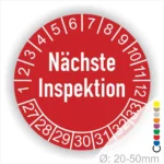 Runder Aufkleber zur Anzeige des nächsten Inspektionsdatums, rot mit weißen Zahlen von 1 bis 12 und Jahreszahlen 27-33, Durchmesser von 20-50 mm.
