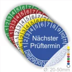 Farbcodierte Prüfplaketten mit dem Hinweis "Nächster Prüftermin" in Blau, umgeben von roten, grünen, gelben und weißen Platten. Ideal zur Kennzeichnung von Prüfintervallen, Durchmesser 20-50 mm.