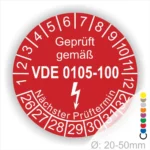 Prüfsiegel gemäß VDE 0105-100 für elektrische Geräte, rot mit Prüfnummern von 1 bis 32 und dem Hinweis auf den nächsten Prüftermin. Durchmesser zwischen 20 und 50 mm.