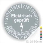 Rundschild mit der Aufschrift "Elektrisch geprüft" und einem Blitzsymbol, das den nächsten Prüftermin anzeigt. Durchmesser zwischen 20 und 50 mm, geeignet für die Kennzeichnung von elektrischen Geräten und Sicherheitsprüfungen.
