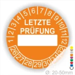 Orange Prüfaufkleber mit der Aufschrift "LETZTE PRÜFUNG" und Platz für das Datum. Der Aufkleber zeigt Zahlen von 1 bis 12 und von 26 bis 32. Durchmesser von 20-50 mm, geeignet für regelmäßige Sicherheitsüberprüfungen.
