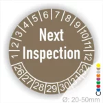 Prüfplaketten, Prüfaufkleber rund, Farbe- grau, Text auf Englisch "Next Inspection" in Weiss. Startjahr- 26, Monatszahlen Oben und Jahreszahlen Unten in Kreisform.