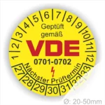 Runde gelbe Prüfplakette „Geprüft gemäß VDE 0701-0702“ mit Monatsring und Jahresring, Blitzsymbol und Hinweis „Nächster Prüftermin“, Ø 20–50 mm