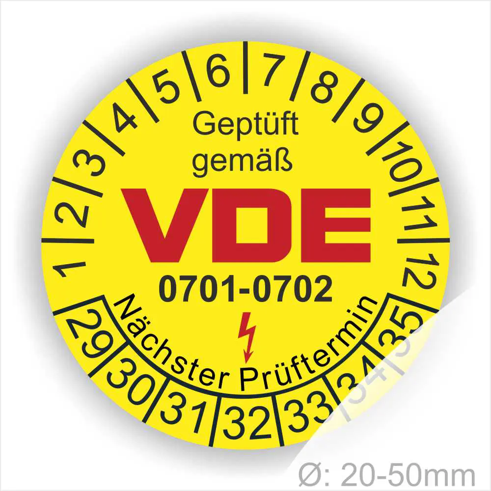 Gelbes VDE Prüfplakette mit der Aufschrift "Geprüft gemäß VDE" und der Prüfnorm 0701-0702. Die Plakette zeigt einen nächsten Prüftermin und einen Durchmesser von 20-50 mm.