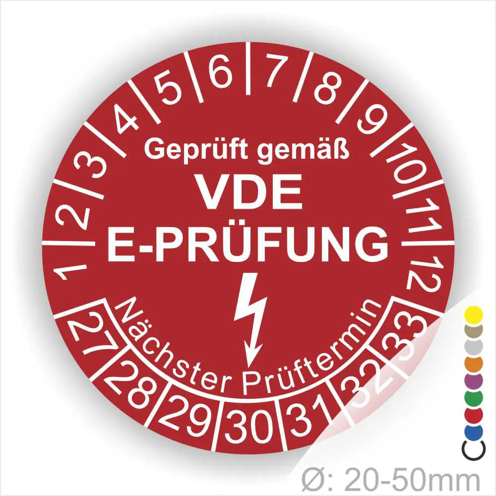 Rotes Prüfplakett mit der Aufschrift "Geprüft gemäß VDE E-Prüfung", das den nächsten Prüftermin anzeigt. Enthält eine Skala von 1 bis 12 und eine weitere von 27 bis 33. Durchmesser zwischen 20 und 50 mm.